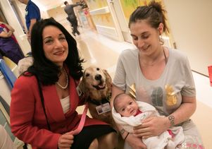 Johnese Spisso, a volunteer dog, baby and mother