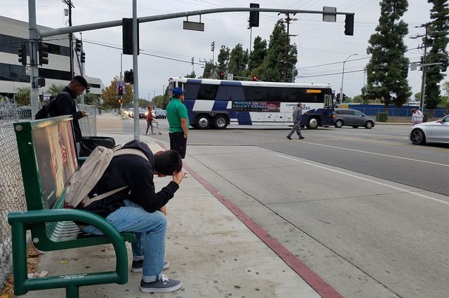 Bus and bus stop at Los Angeles intersection