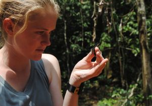Cara Newberry examines a butterfly.