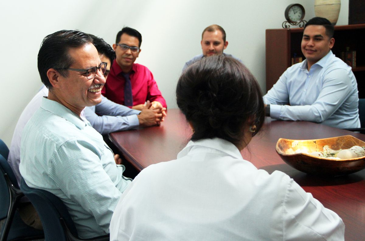 Dr. Michelle Bholat with students