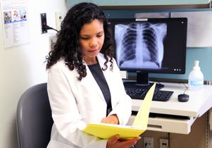 Dr. Edna Elvira Biddy reviews a patient’s chart