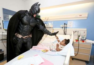 Superhero window washers visit young patients