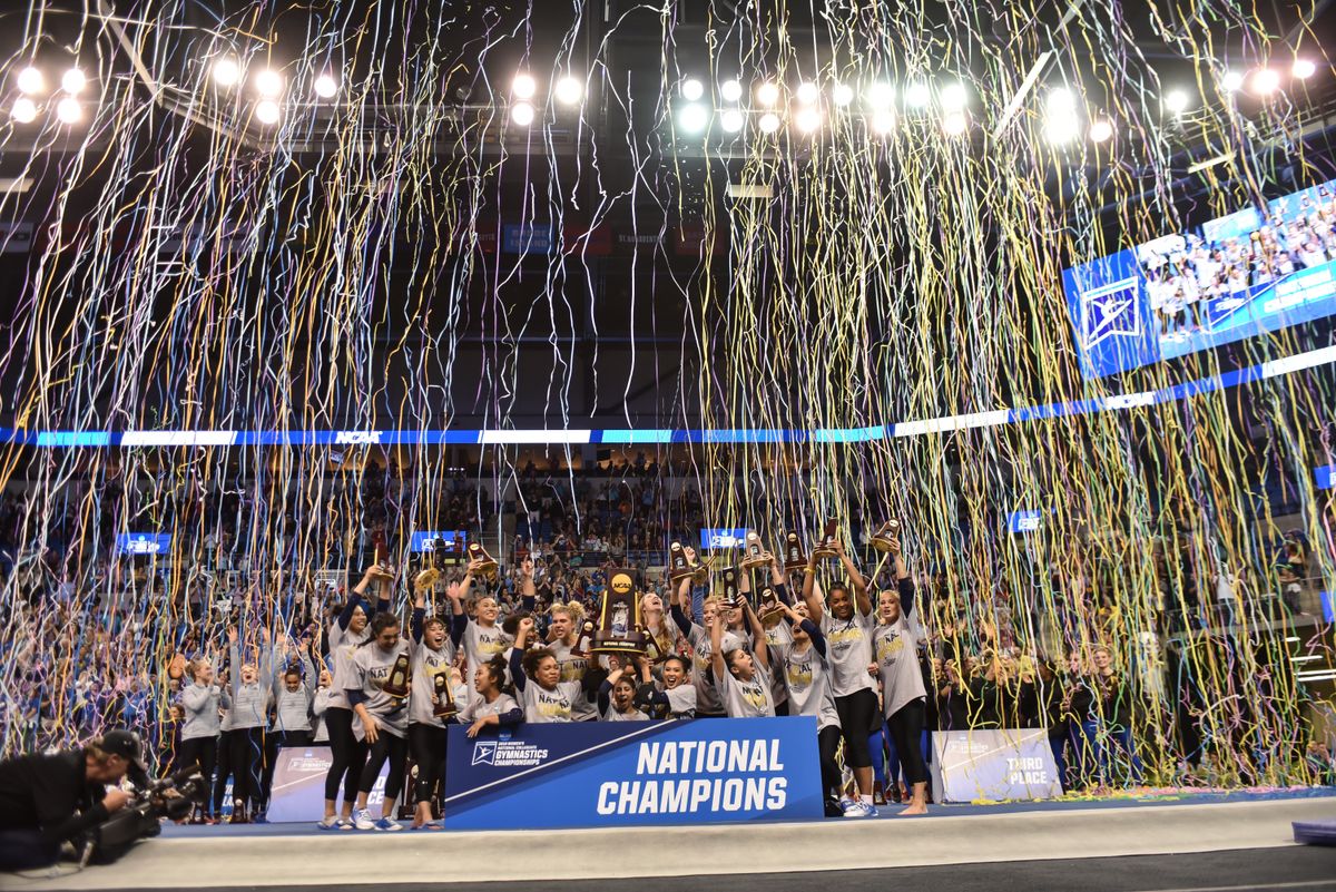 UCLA gymnastics team with streamers