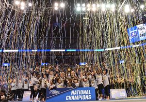 UCLA gymnastics team with streamers
