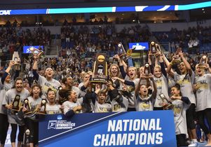 UCLA gymnastics with NCAA trophy