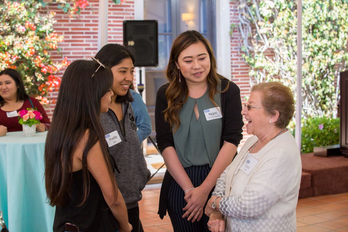 Carol Block talks with students at the Advocates for Women’s Empowerment and Leadership reception