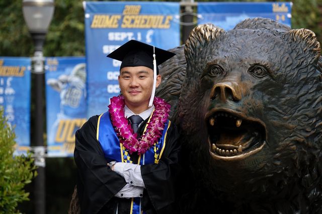 Graduate at bear statue