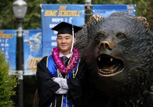 Graduate at bear statue