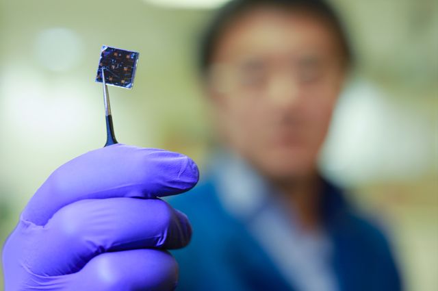 Qifeng Han holds solar cell