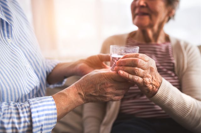 Elderly woman with a glass of water