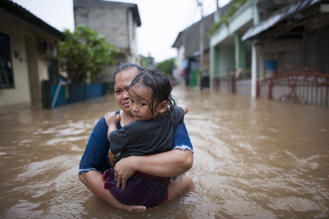 Woman and child in Jakarta flood