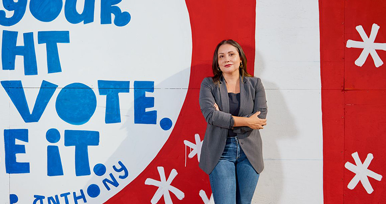 Sonja Diaz, the founding director of the Latino Policy & Politics Initiative, stands in front of Eric Junker’s vote mural in Atwater Village.