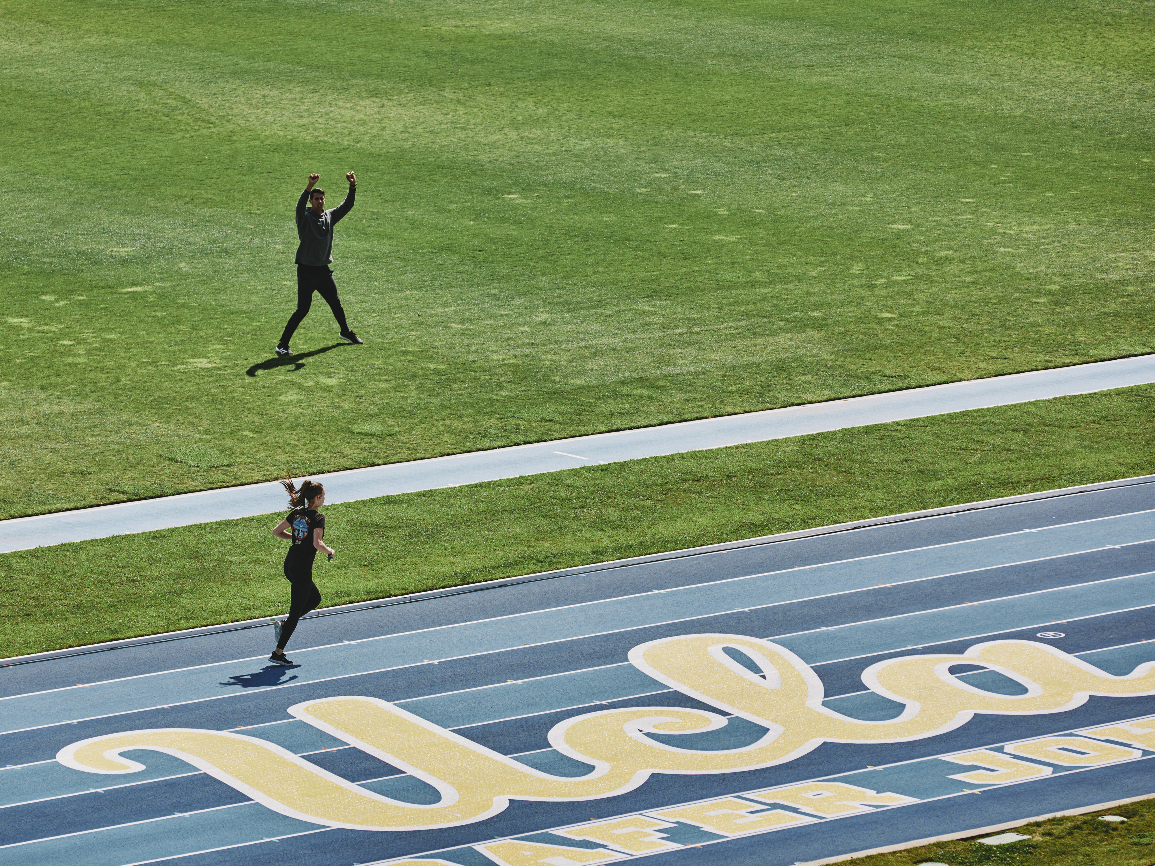 Woman runs around the track at UCLA’s Drake Stadium.