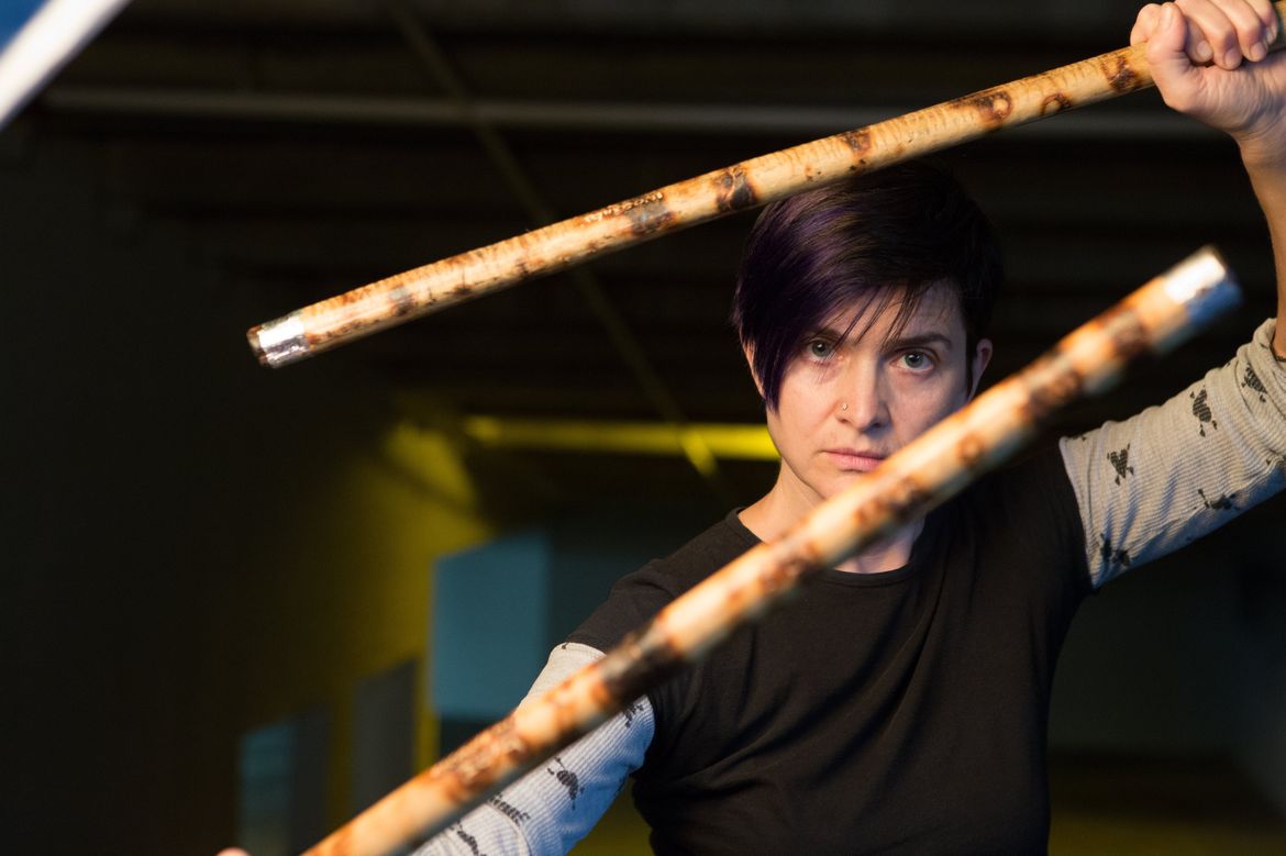 Janet O’Shea holding sticks used in martial arts