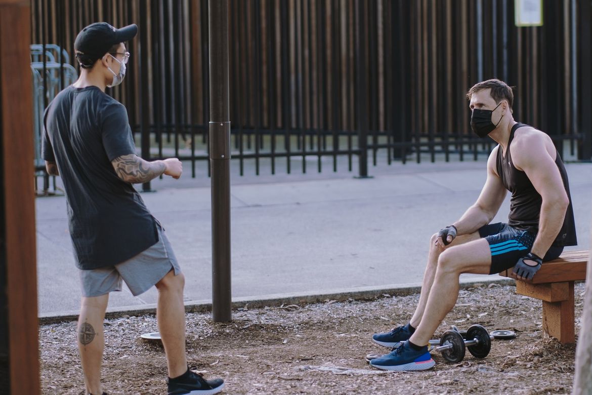 Men with face coverings in park
