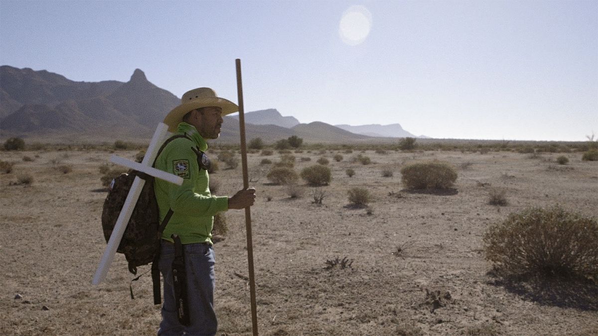 Man in desert with cross