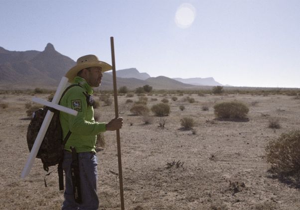 Man in desert with cross