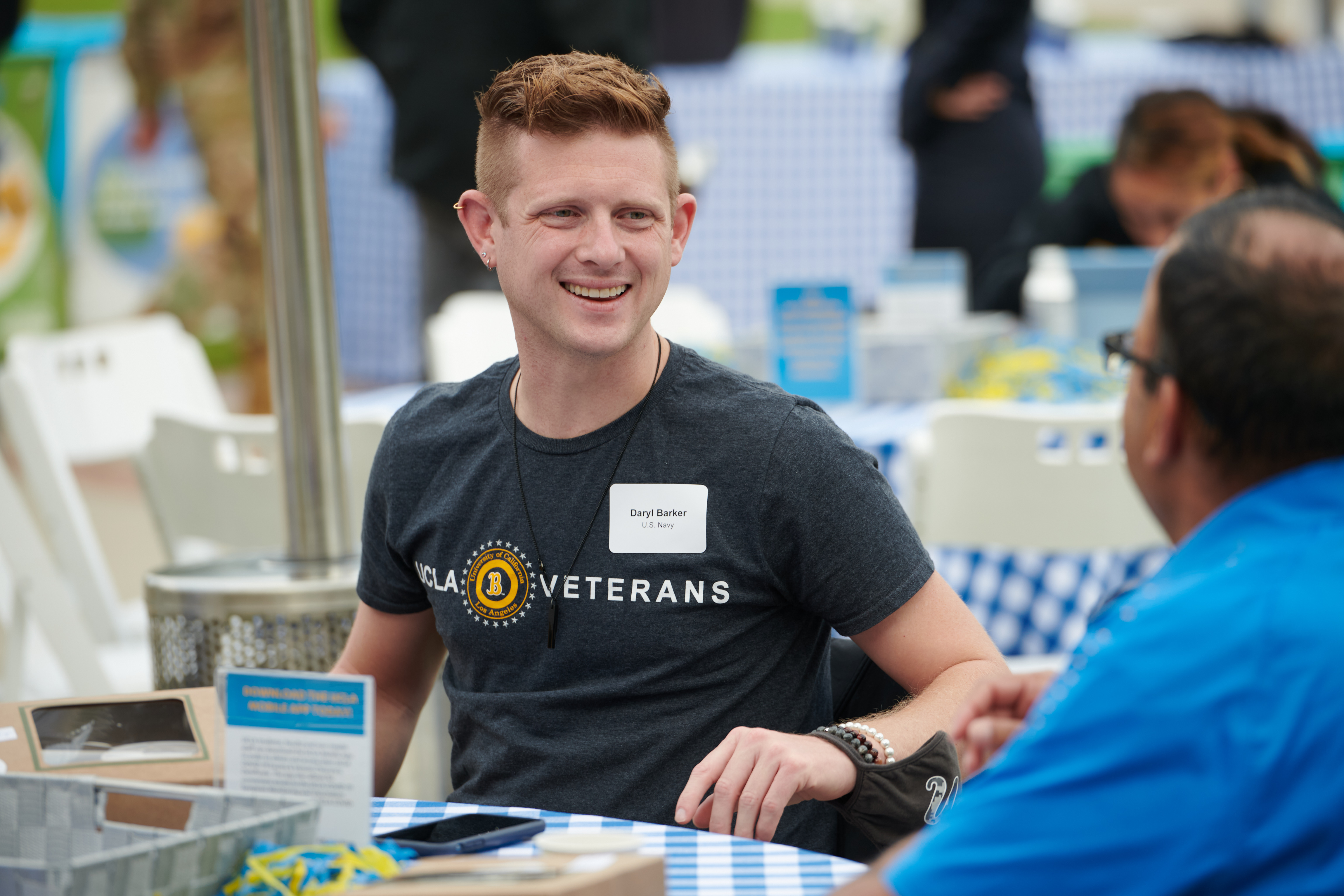 Daryl Barker seated at table with other vets