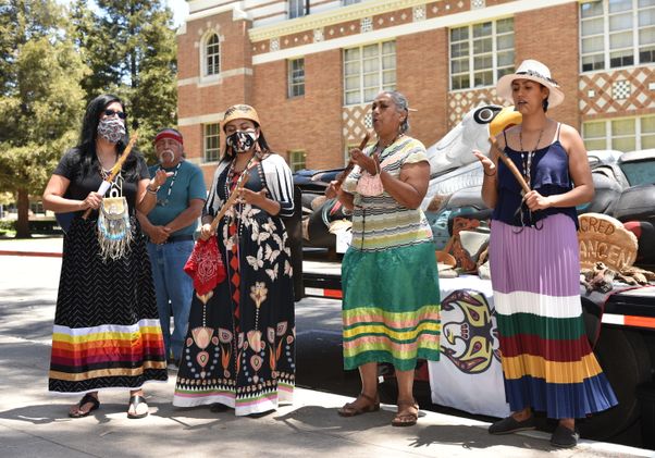 Lummi totem at UCLA with singers