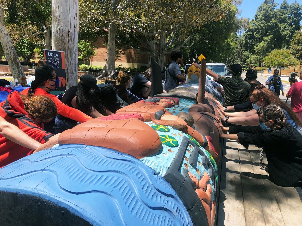 Participants touch the Lummi totem and offer a final blessing. Participants touch the Lummi totem and offer a final blessing.