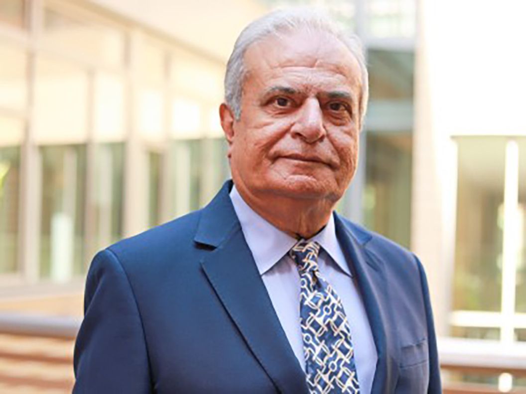 Head-and-shoulders photo of Asad Madni in suit and tie