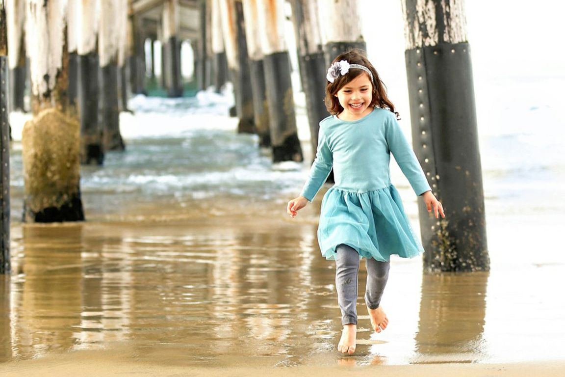 Evangelina Vaccaro running beneath pier