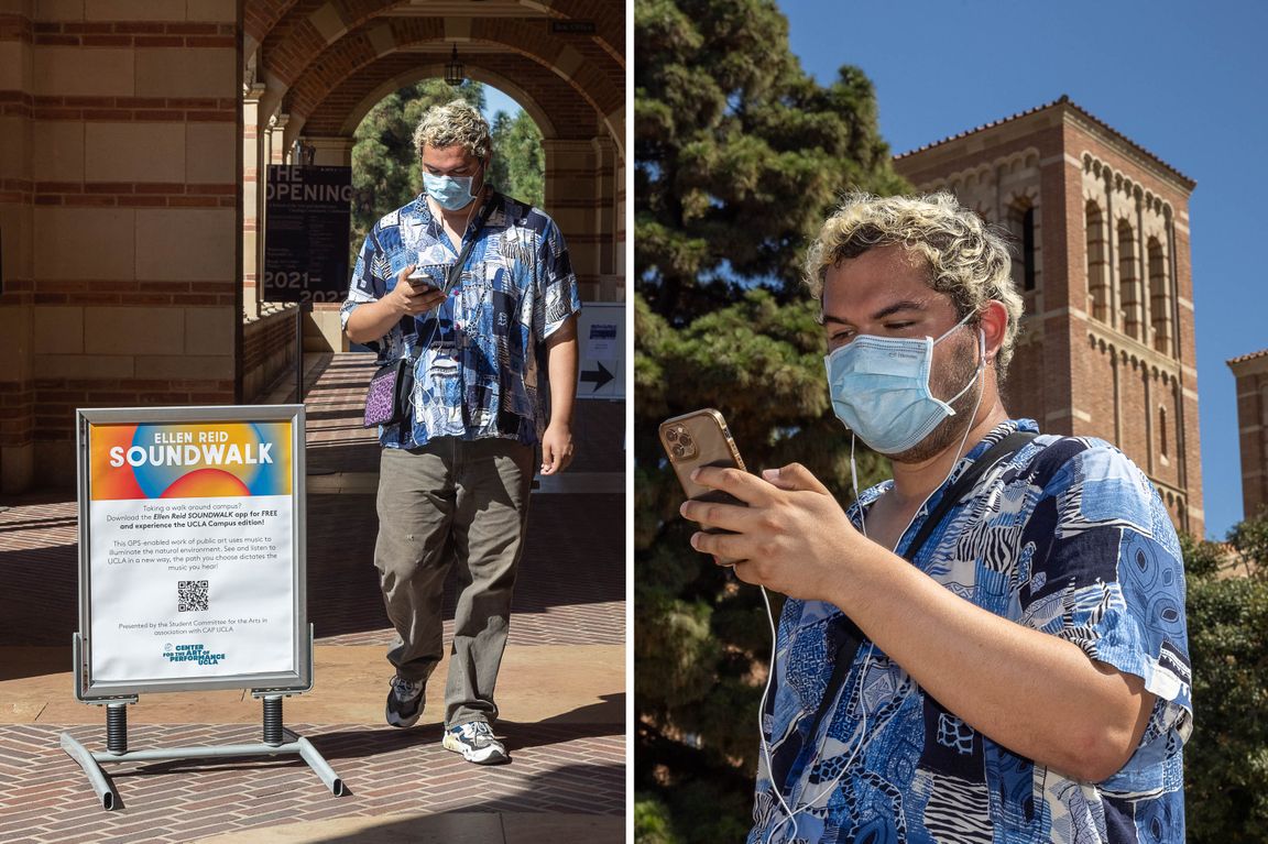 Art student walks on campus with phone 
