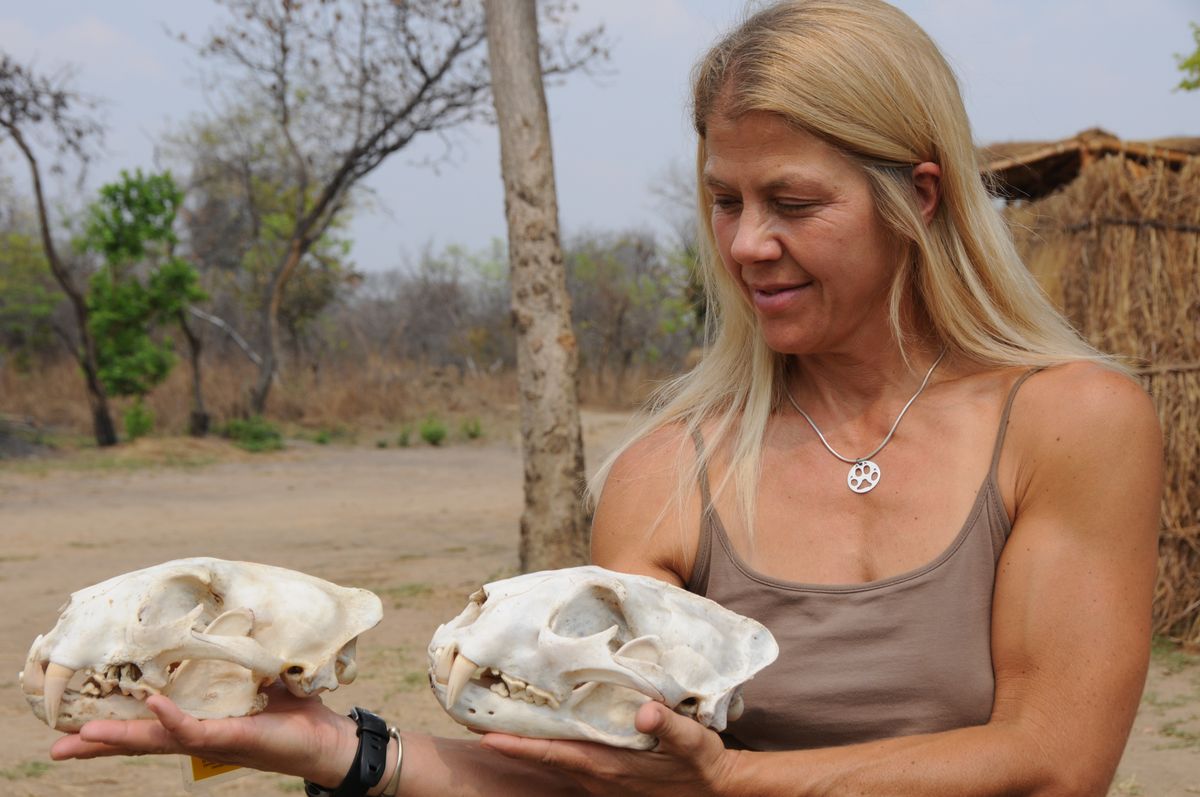 Paula White in field with leopard skulls