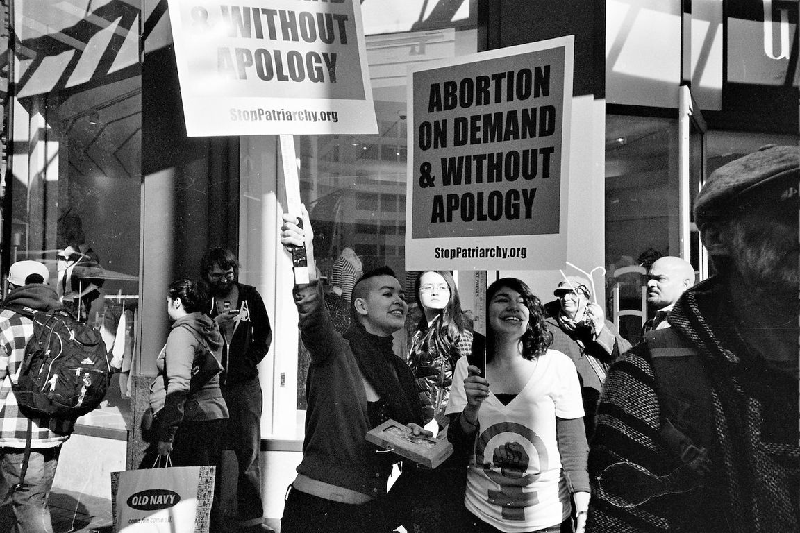Black-and-white photo of two women with signs at pro-abortion protest