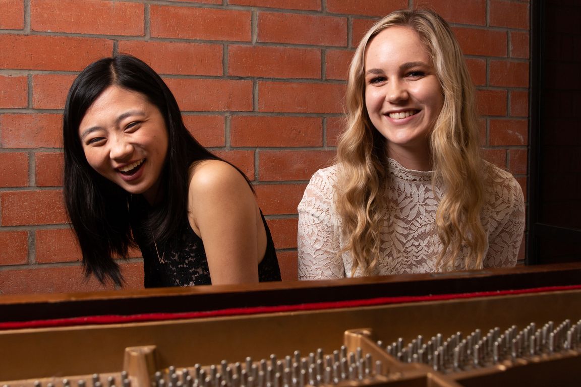 Sydney Hsueh and Ashley Bowman at a piano