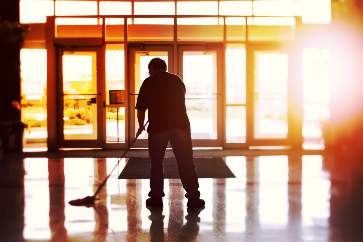 Custodial worker in building lobby
