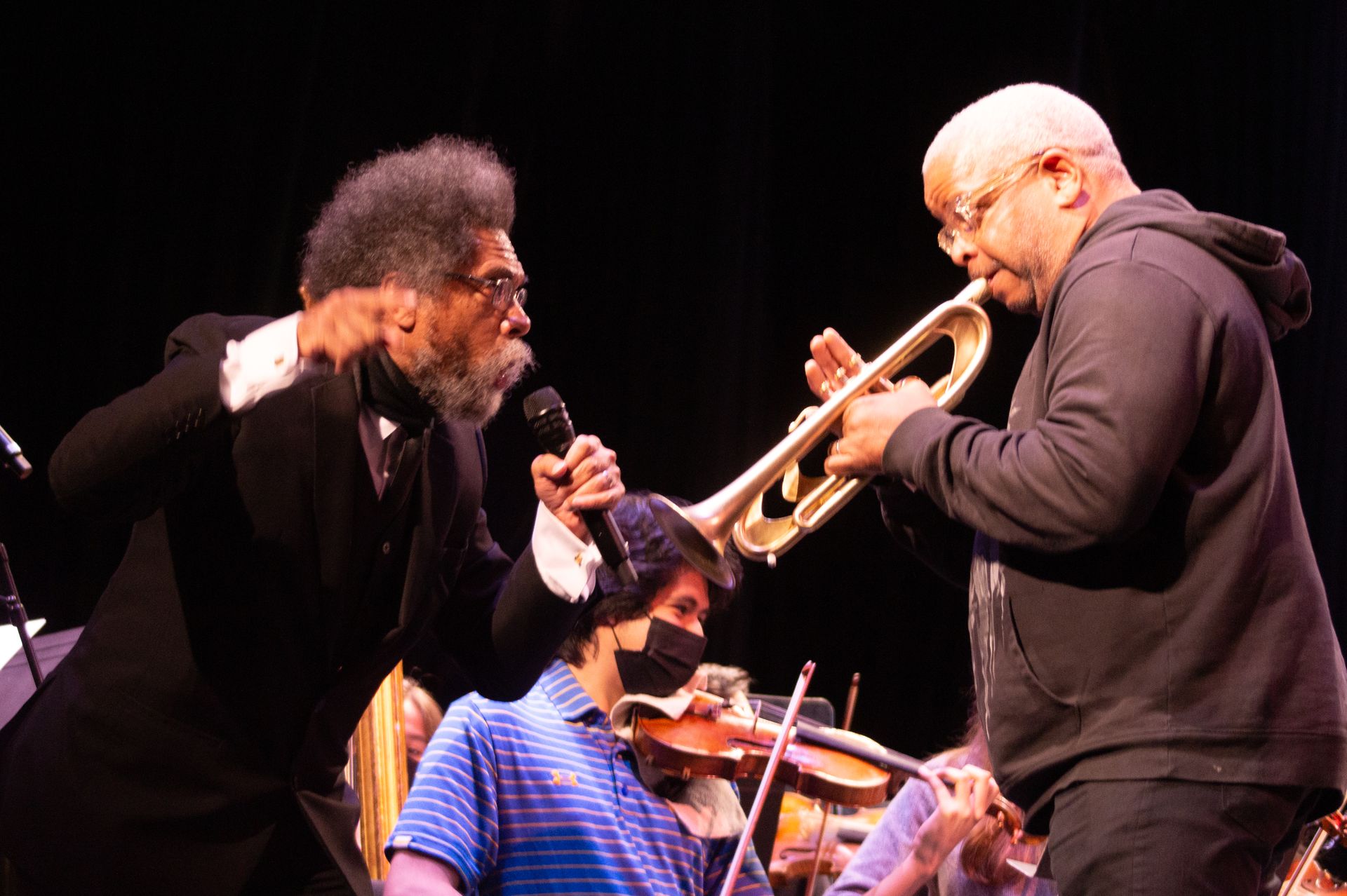 Cornel West, left, Christian Gonzales on violin, center, Terence Blanchard on trumpet