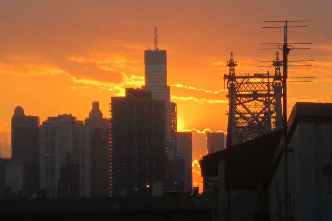 City buildings silhouetted by the sun