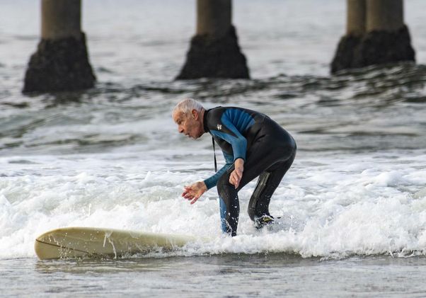 Robert Lombard surfing after knee replacement surgery