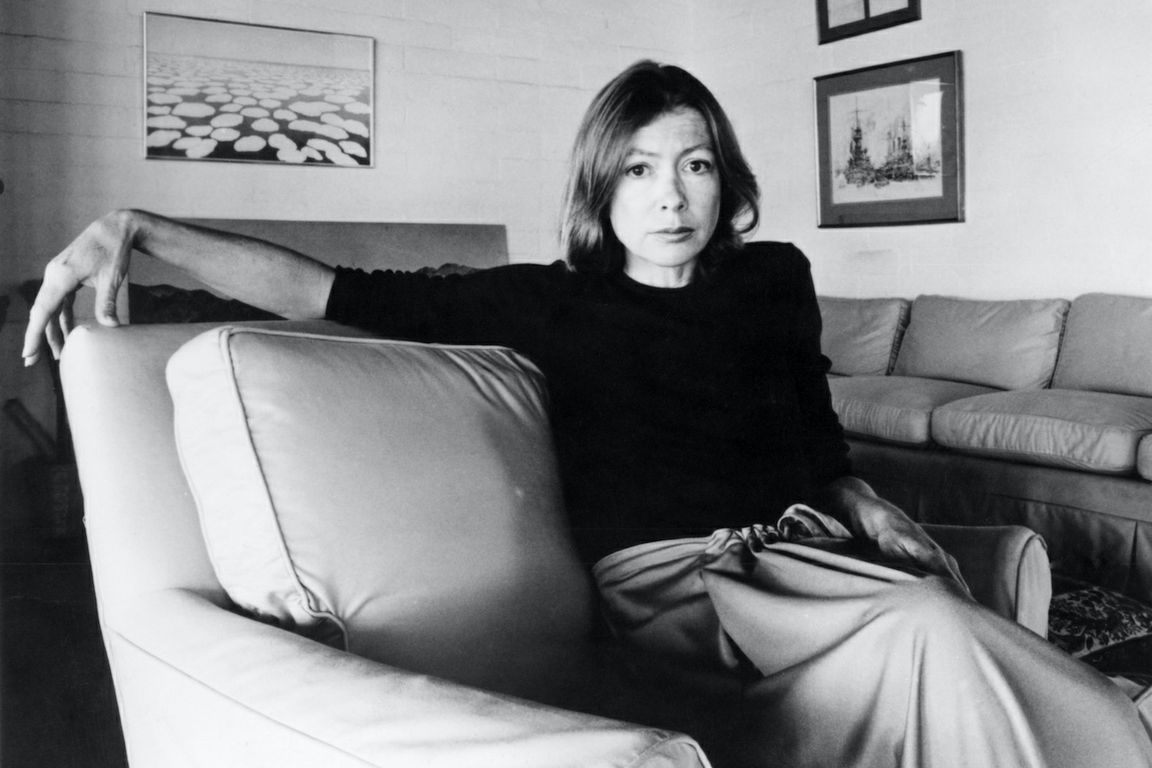 Joan Didion sitting in chair