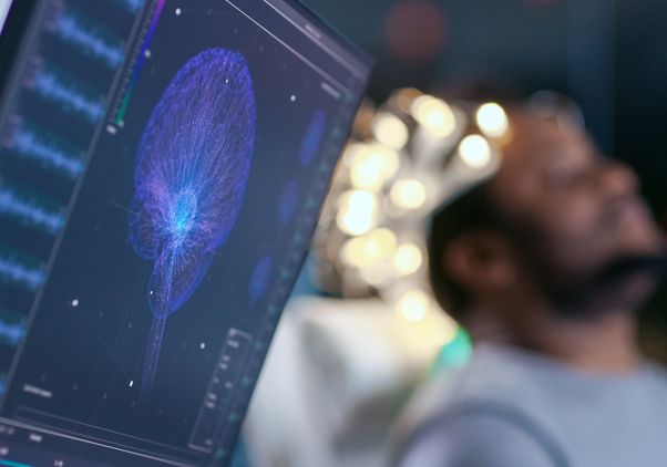 Brain scan on computer screen with patient in background
