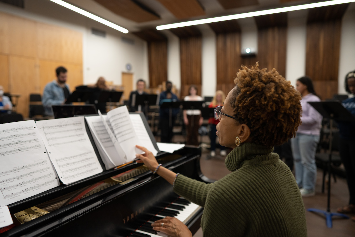 White-Clayton rehearsing with students in the Schoenberg Music Building Diane White-Clayton at piano, with students in background