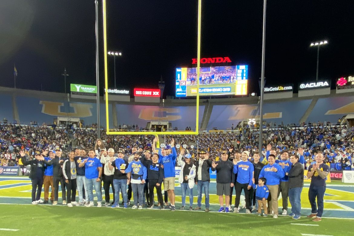 Photo Group of about 20 UCLA veterans on the field at the Rose Bowl