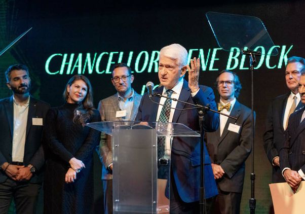 Chancellor Block speaking at podium after receiving award from LABC, with others in the background