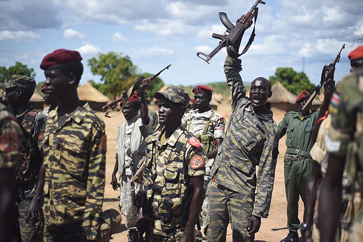 Soldiers in Sudan, some holding rifles up in the air