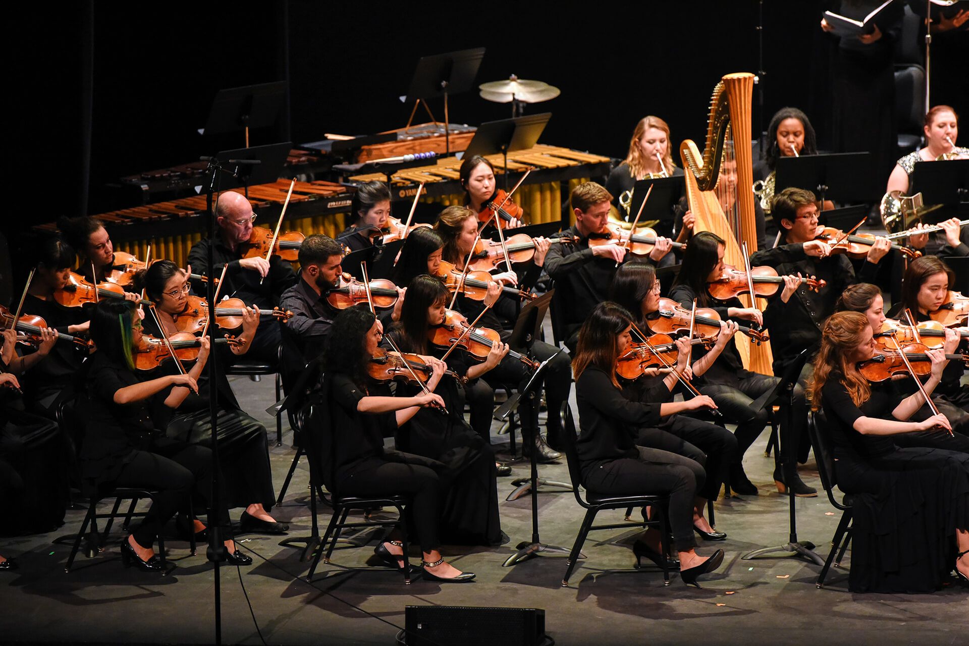 UCLA Symphony members on stage playing instruments