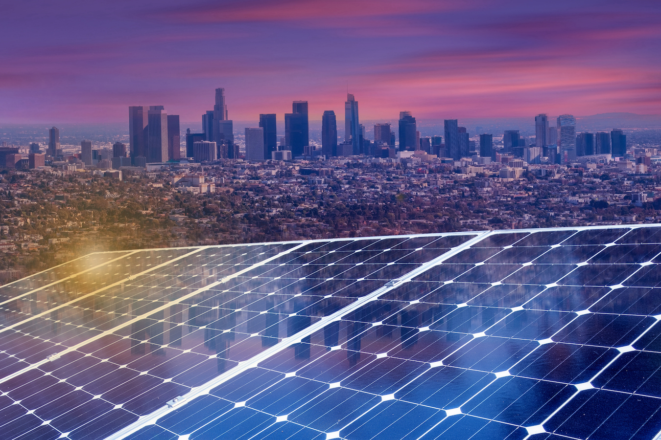 Photo illustration of solar panels in foreground with downtown L.A. in background