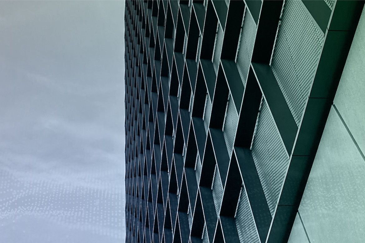 Image of side of a building with gray skies in background