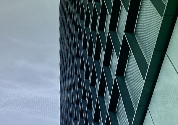 Image of side of a building with gray skies in background