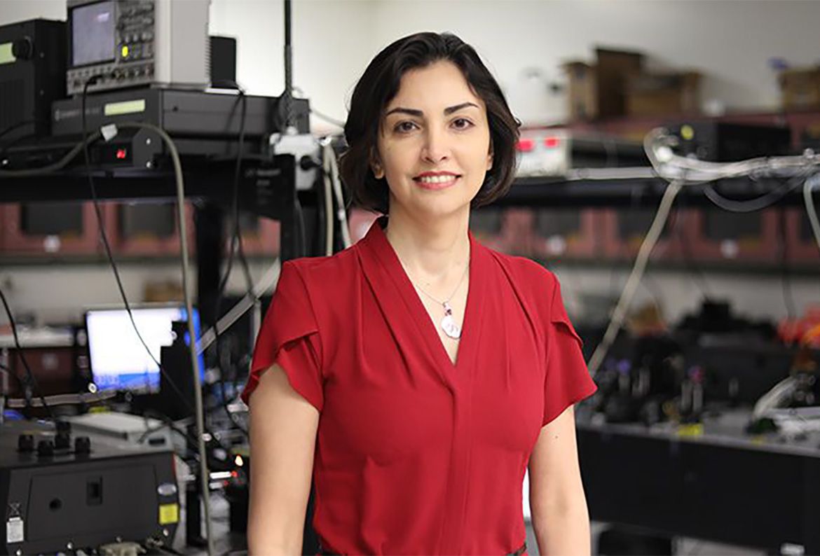 Mona Jarrahi wears a red shirt in an electronics library