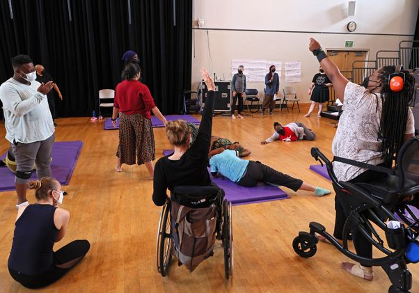 Disabled dancers in motion photographed from behind