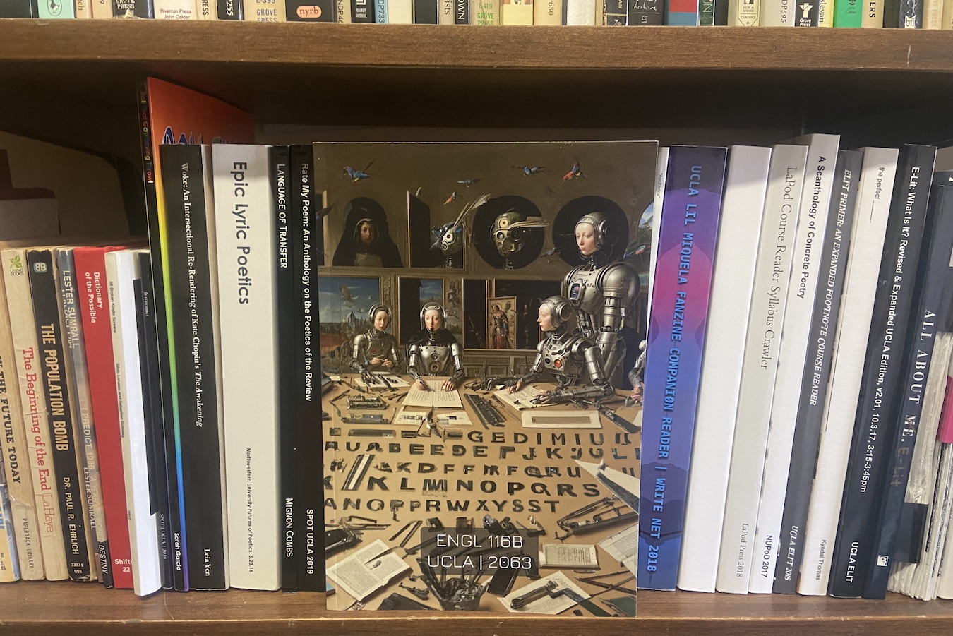 “Algo Lit” book cover showing humanoid robots and letters from the alphabet, on bookshelf.