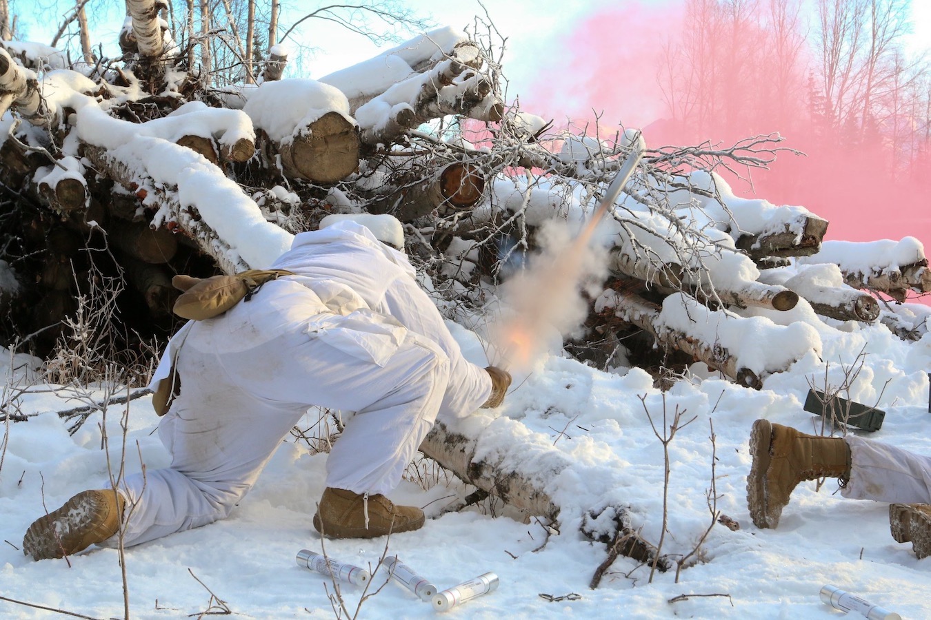 Nam Yong Chu in white combat outfit in wilderness and snow shooting off rocket.