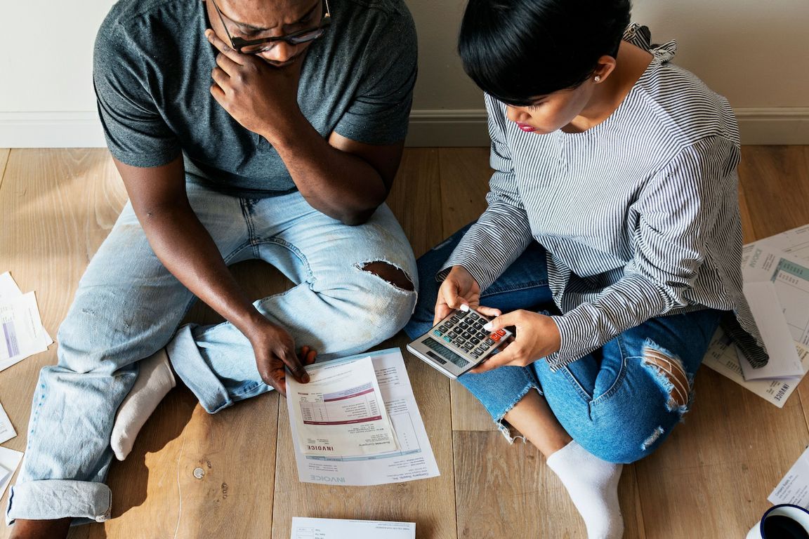 Couple on floor looking at billing statements