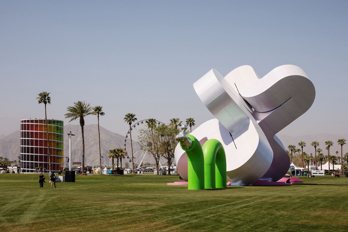 Wide shot of “Holoflux” installation with Ferris wheel and other structures in background
